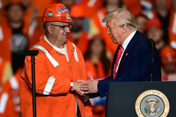 President Donald Trump greets steelworker Brian Pavlack as he speaks at the U.S. Steel Mon Valley Works-Irvin plant, Friday, May 30, 2025, in West Mifflin, Pa. (AP Photo/David Dermer)