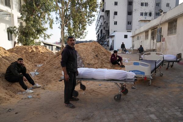 The bodies of Palestinians killed in an Israeli army airstrikes are brought to Shifa hospital in Gaza City, Tuesday, March 18, 2025. (AP Photo/Abdel Kareem Hana)