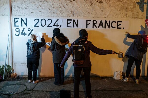 Members of the feminist collective "Les Amazones Avignon" post a message of support for Gisele Pelicot reading "In France in 2024, 94 percent of the rapist are acquitted" near the courthouse where the Mazan rape trial is taking place, in Avignon, Wednesday, Dec. 18, 2024. (AP Photo/Lewis Joly)