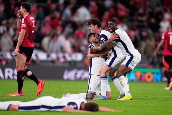 Tottenham players, from right, Kevin Danso, Archie Gray, and Cristian Romero celebrate after winning the Europa League final soccer match against Manchester United at the San Mames Stadium in Bilbao, Spain, Wednesday, May 21, 2025. (AP Photo/Manu Fernandez)