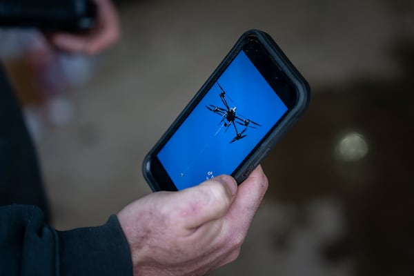 Russell Hedrick shows footage of when he used his drone to drop supplies to people during Hurricane Helene recovery, Tuesday, Dec. 17, 2024, in Hickory, N.C. (AP Photo/Allison Joyce)