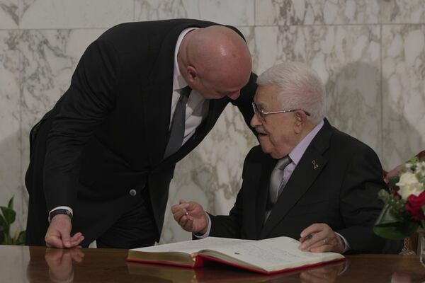 Palestinian President Mahmoud Abbas, right, speaks with Lebanese President Joseph Aoun, as he signs a guest book at the Presidential Palace, in Baabda, east of Beirut, Lebanon, Wednesday, May 21, 2025. (AP Photo/Hassan Ammar)