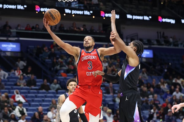 New Orleans Pelicans guard CJ McCollum (3) shoots a layup against Utah Jazz forward Cody Williams in the second half of an NBA basketball game in New Orleans, Monday, Jan. 20, 2025. (AP Photo/Peter Forest)