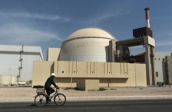 FILE - A worker rides a bicycle in front of the reactor building of the Bushehr nuclear power plant, just outside the southern city of Bushehr, Iran, Oct. 26, 2010. (Majid Asgaripour/Mehr News Agency via AP, File)