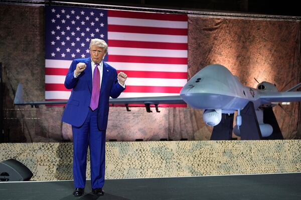 President Donald Trump gestures backdropped by an MQ-9 Reaper drone at the Al Udeid Air Base, Thursday, May 15, 2025, in Doha, Qatar. (AP Photo/Alex Brandon)