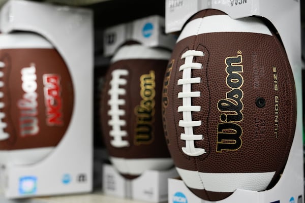 Footballs are displayed on shelves at a Walmart, Wednesday, April 16, 2025, in Groton, Conn. (AP Photo/Julia Demaree Nikhinson)