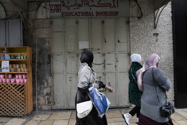 The shuttered Educational Bookshop is seen after Israeli police raided of the long-established Palestinian-owned bookstore in east Jerusalem, detaining its owners and confiscating books about the decades-long conflict saying the books incited violence, Monday, Feb. 10, 2025. (AP Photo/Mahmoud Illean)