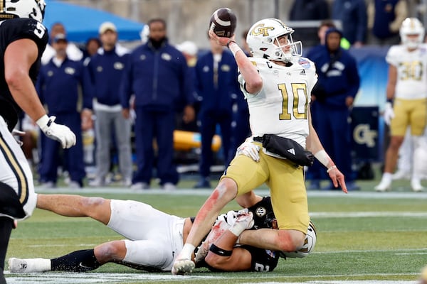 Georgia Tech quarterback Haynes King (10) is sacked by Vanderbilt linebacker Nicholas Rinaldi, bottom, during the first half of the Birmingham Bowl NCAA college football game, Friday, Dec. 27, 2024, in Birmingham, Ala. (AP Photo/Butch Dill)