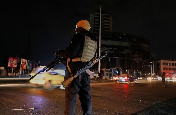 A member of the government security forces stands guard at a street in Damascus, Syria, Thursday, March 6, 2025. (AP Photo/Omar Sanadiki)