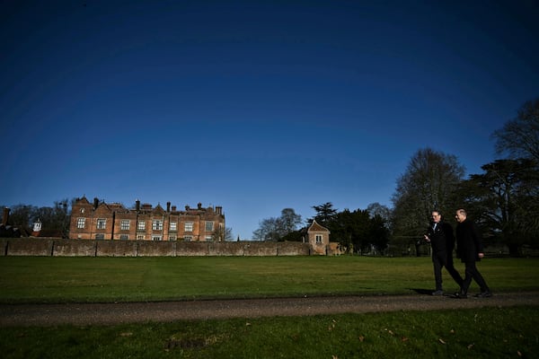 Britain's Prime Minister Keir Starmer, left, walks with Germany's Chancellor Olaf Scholz in the garden of the Chequers, in Aylesbury, England, Sunday, Feb. 2, 2025. (Ben Stansall/Pool Photo via AP)