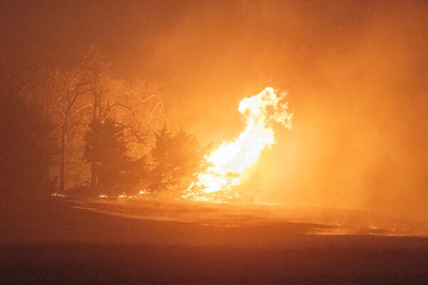 A wildfire burns at night on Friday, March 14, 2025, south of Langston, Okla. (AP Photo/Alonzo Adams)