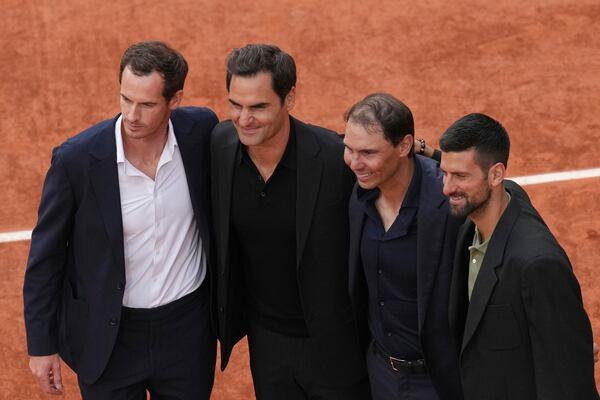 Rafa Nadal, second right, poses with, from left, Andy Murray, Roger Federer and Novak Djokovic, right, during a farewell ceremony at center court Philippe-Chatrier, at the Roland-Garros stadium, in Paris, Sunday May 25, 2025. (AP Photo/Christophe Ena)