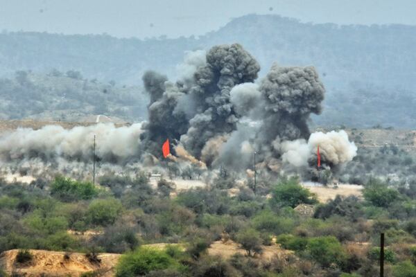 In this photo released by the Inter Services Public Relations, smoke erupts on mock target after Pakistani army artillery fire shell during a military exercises, in Tilla Field Firing Range, in the Jhelum district, Pakistan, Thursday, May 1, 2025. (Inter Services Public Relations via AP)