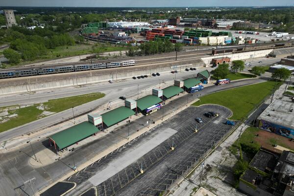 A Metra train, top, is seen in the tracks across from the Pace Harvey Transportation Center, Thursday, May 29, 2025, in Harvey, Ill. (AP Photo/Erin Hooley)