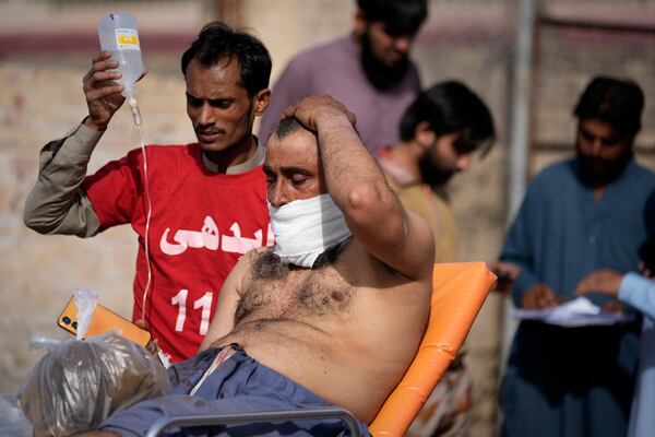 An injured passenger rescued by security forces from a passenger train attacked by insurgents arrive at a railway station in Much near Quetta, Pakistan's southwestern Balochistan province, Wednesday, March 12, 2025. (AP Photo/Anjum Naveed)