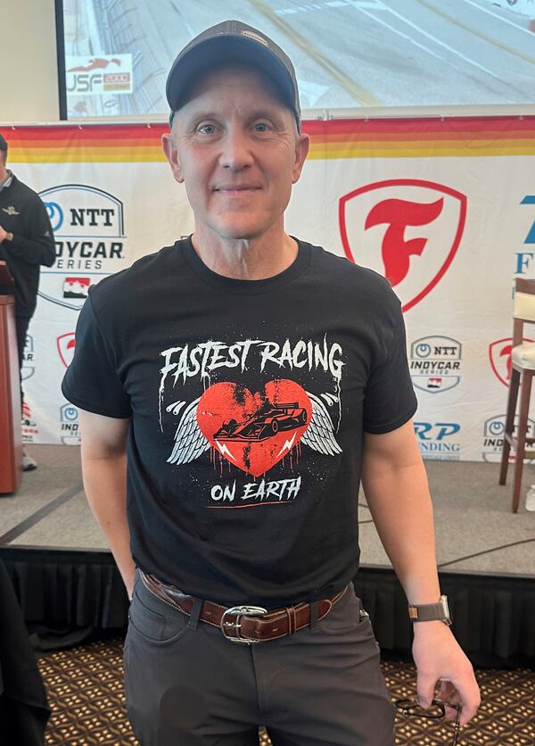 FOX Sports CEO & Executive Producer Eric Shanks poses in a T-shirt he designed to promote the IndyCar auto racing season on March 4, 2025, in St. Petersburg, Fla. (AP Photo/Jenna Fryer)