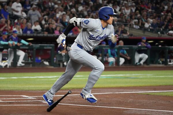 Los Angeles Dodgers' Shohei Ohtani starts to run after hitting a single against the Arizona Diamondbacks in the first inning during a baseball game, Saturday, May 10, 2025, in Phoenix. (AP Photo/Rick Scuteri)