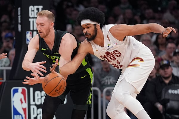 Cleveland Cavaliers center Jarrett Allen, right, steals the ball from Boston Celtics forward Sam Hauser, left, during the first half of an NBA basketball game, Friday, Feb. 28, 2025, in Boston. (AP Photo/Charles Krupa)