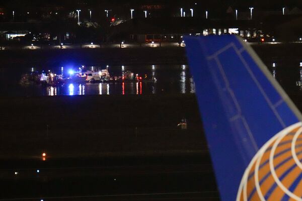 Boats work the scene on the Potomac River near Ronald Reagan Washington National Airport, Thursday, Jan. 30, 2025, in Arlington, Va. (AP Photo/Julio Cortez)