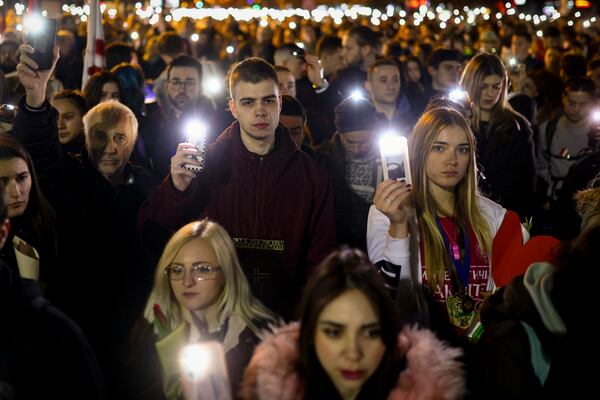 People hold up their mobile phone lights during a protest over the collapse of a concrete canopy that killed 15 people more than two months ago, in Novi Sad, Serbia, Friday, Jan. 31, 2025. (AP Photo/Armin Durgut)