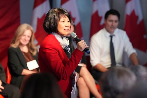 Prime Minister Justin Trudeau, back right, and former Alberta premier Rachel Notley, back left, look on as Toronto Mayor Olivia Chow addresses a Canada-U.S. economic summit in Toronto, Friday, Feb. 7, 2025. (Frank Gunn/The Canadian Press via AP)