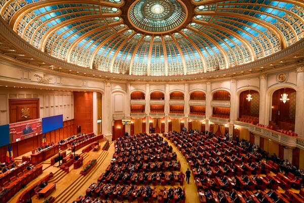 Newly elected members of parliament attend a confidence vote for Romanian Prime Minister designate Marcel Ciolacu, the leader of the Social Democratic party, and his team, at the parliament in Bucharest, Romania, Monday, Dec. 23, 2024. (AP Photo/Vadim Ghirda)