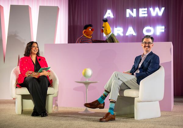 Sal Perez, executive producer and VP of Sesame Street at Sesame Workshop, right, and Versha Sharma, editor-in-chief at Teen Vogue, talk to Burt and Ernie after Sesame Workshop won the Elevate Prize Foundation's Catalyst Award, Wednesday, May 14, 2025, in Miami Beach, Fla. (AP Photo/Michael Laughlin)