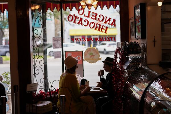 Patrons sit inside Angelo Brocato in New Orleans, Wednesday, Jan. 29, 2025. (AP Photo/Gerald Herbert)