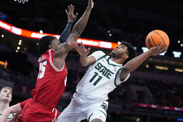 Michigan State guard Jase Richardson (11) shoots on Wisconsin guard John Blackwell (25) during the first half of an NCAA college basketball game in the semifinals of the Big Ten Conference tournament in Indianapolis, Saturday, March 15, 2025. (AP Photo/Michael Conroy)