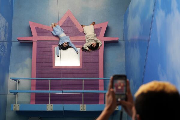 Sisters Hallel, left, and Tohar Azulay pose for a picture in an installation using mirrors to create an optical illusion, at Paradox Museum Miami, Tuesday, Jan. 28, 2025, in Miami. (AP Photo/Rebecca Blackwell)