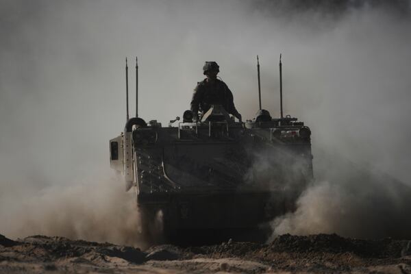 Israeli troops move with APC, armored personnel carrier near the border with Gaza, in southern Israel, Thursday, May 8, 2025. (AP Photo/Ariel Schalit)