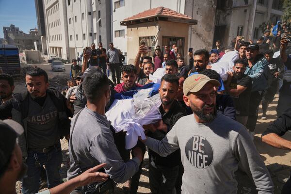 The body of Palestinian journalist Yahya Sobeih, center, who was killed along with at least 28 others in an Israeli army strike on a restaurant, is carried at Shifa hospital in Gaza City, Wednesday, May 7, 2025.(AP Photo/Jehad Alshrafi)