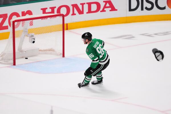 A hat is thrown onto the ice as Dallas Stars' Mikko Rantanen (96) scores an empty-net goal against to earn a hat trick in the third period in Game 7 of a first-round NHL hockey playoff series againts the Colorado Avalanche Saturday, May 3, 2025, in Dallas. (AP Photo/Julio Cortez)