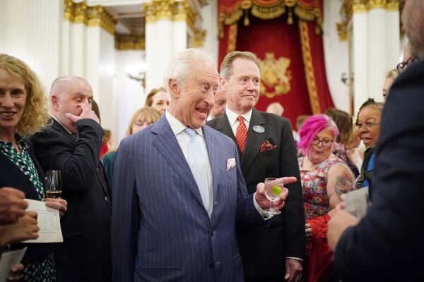 Britain's King Charles III speaks to guests during a reception in Buckingham Palace, London, in celebration of community-based initiatives raising awareness about cancer and supporting those living with cancer, Wednesday April 30, 2025. (Yui Mok/Pool Photo via AP)
