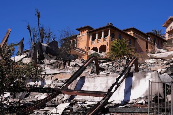 A home stands above debris from the Palisades Fire in Malibu, Calif., Sunday, Jan. 12, 2025. (AP Photo/Mark J. Terrill)