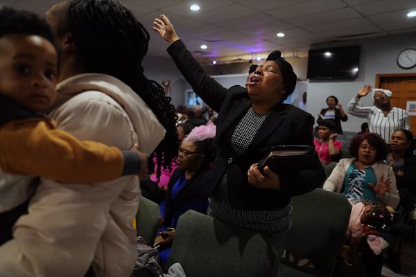 Matana Picard Merceus worships with Rolando Sumeus and her son, left, and other congregants at the First Haitian Evangelical Church of Springfield, Sunday, January 26, 2025, in Springfield, Ohio. (AP Photo/Jessie Wardarski)