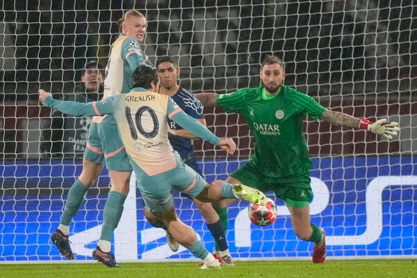 Manchester City's Jack Grealish scores his sides opening goal during the Champions League opening phase soccer match between Paris Saint-Germain and Manchester City at the Parc des Princes in Paris, Wednesday, Jan. 22, 2025. (AP Photo/Michel Euler)