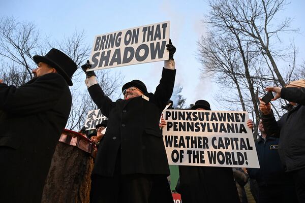 Groundhog Club member Butch Philliber displays a sign following the forecast by Punxsutawney Phil, the weather prognosticating groundhog, during the 139th celebration of Groundhog Day on Gobbler's Knob in Punxsutawney, Pa., Sunday, Feb. 2, 2025. Phil's handlers said that the groundhog has forecast six more weeks of winter. (AP Photo/Barry Reeger)