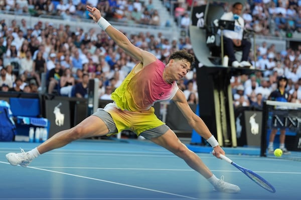 Ben Shelton of the U.S. plays a backhand return to Lorenzo Musetti of Italy during their third round match at the Australian Open tennis championship in Melbourne, Australia, Saturday, Jan. 18, 2025. (AP Photo/Ng Han Guan)