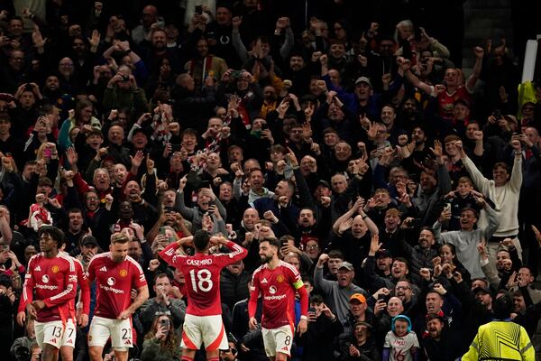 Manchester United's Casemiro celebrates with fans during the Europa League semifinal second leg soccer match between Manchester United and Athletic Bilbao in Manchester, Britain, Thursday, May 8, 2025. (AP Photo/Dave Thompson )