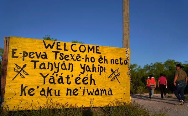 A welcome sign written in several different Native American languages at the entrance to the Indigenous Peyote Conservation Initiative homesite, led by several leaders within the Native American Church, in Hebbronville, Texas, Sunday, March 24, 2024. (AP Photo/Jessie Wardarski)