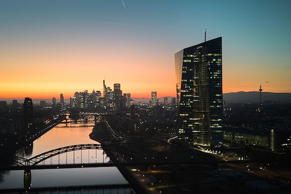 The sun has set behind the European Central Bank, right, in Frankfurt, Germany, Wednesday, March 5, 2025, the day before the meeting of the ECB's governing council. (AP Photo/Michael Probst)