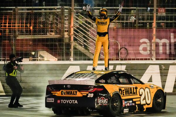 Christopher Bell (20) celebrates his victory after a NASCAR Cup Series auto race, Sunday, Feb. 23, 2025, in Hampton, Ga. (AP Photo/Mike Stewart)