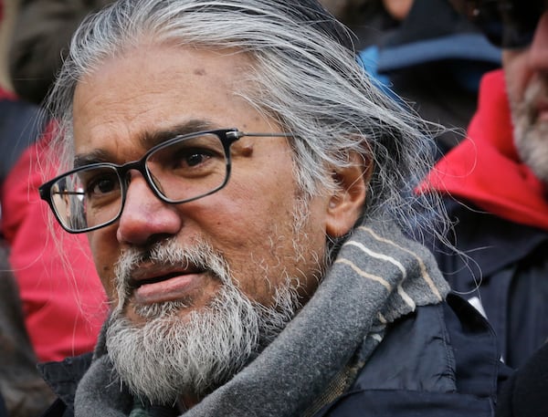 FILE- Immigration activist Ravi Ragbir, listens during a news conference at New York City Hall called by city council members on his behalf, Jan. 31, 2018. AP Photo/Bebeto Matthews, File)