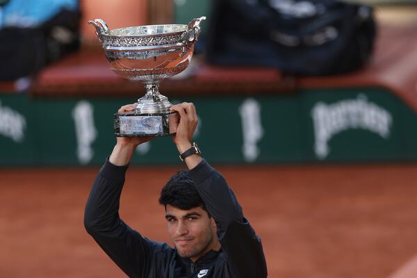 FILE - Winner Spain's Carlos Alcaraz celebrates with the trophy as he won the men's final match of the French Open tennis tournament against Germany's Alexander Zverev at the Roland Garros stadium in Paris, June 9, 2024. (AP Photo/Aurelien Morissard, File)