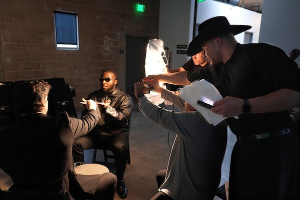 Retired NFL linebacker Brennan Scarlett, right, directs actor and retired NFL player Miles Burris, left, and Isaac Ukwu of the Detroit Lions in a scene from "The Matrix" during a filmmaking workshop for NFL players on Tuesday, March 4, 2025, in Santa Monica, Calif. (AP Photo/Chris Pizzello)