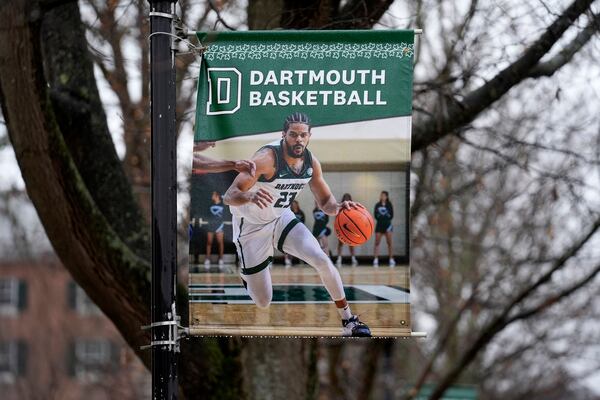 FILE - A poster of a basketball player is attached to a lamppost on the campus of Dartmouth College, March 5, 2024, in Hanover, N.H. (AP Photo/Robert F. Bukaty, File)