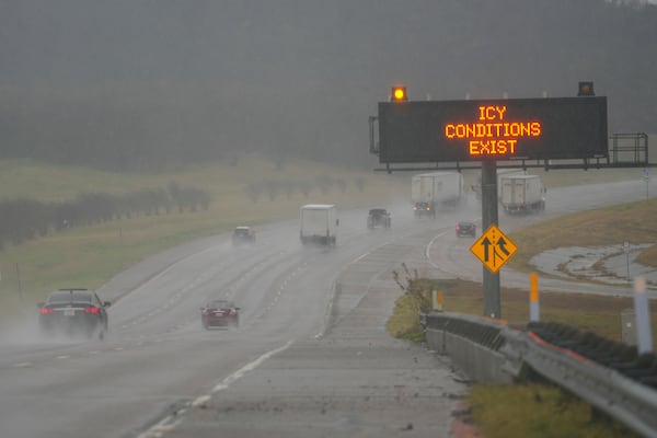 A sign warns motorists of icy conditions along Interstate-20 during a winter storm, Thursday, Jan. 9, 2025, in Grand Prairie, Texas. (AP Photo/Julio Cortez)