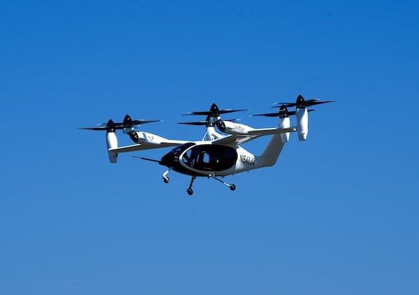 An "electric vertical take-off and landing" aircraft built by Joby Aviation flies over an airfield in Marina, Calif. on Monday, Oct. 7, 2024. (AP Photo/Terry Chea)