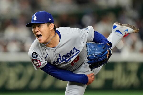 Los Angeles Dodgers starting pitcher Yoshinobu Yamamoto throws to the Chicago Cubs in the fifth inning of an MLB Japan Series baseball game in Tokyo, Japan, Tuesday, March 18, 2025. (AP Photo/Hiro Komae)